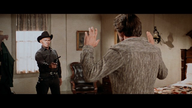 Two characters sitting in a diner, one wearing a blue beanie with 'SNOOGANS' and the other wearing a cap, both looking intently at something off-screen.