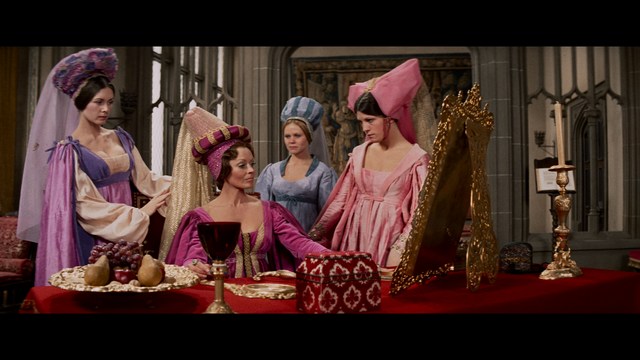 A young man pointing a handgun while seated in a bus, showcasing an intense expression.