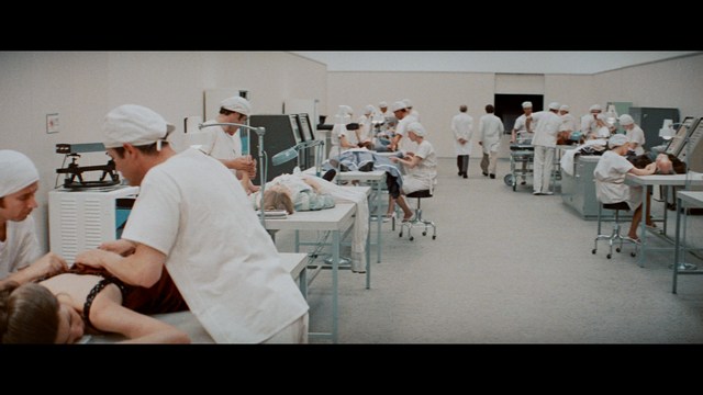 Two characters wearing red bandanas look surprised while standing in a dimly lit indoor setting.
