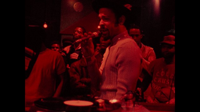 Three characters looking down with surprised expressions, framed from below.