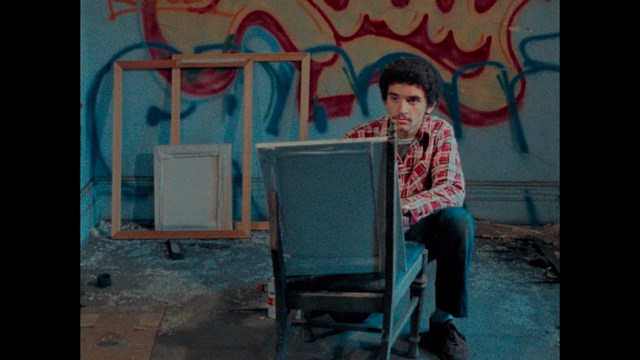 A scene featuring five characters in a bar setting, with a focus on their expressions and interactions. The backdrop includes bar shelves with bottles and a bartender visible in the background.